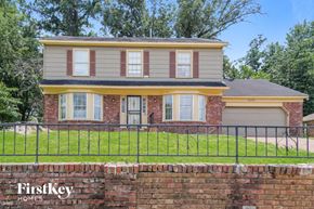 Memphis house for rent - a house with a brick wall and a fence in front of it