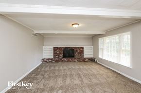 Memphis house for rent - the living room of an empty house with a fireplace