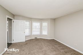 Memphis house for rent - an empty living room with carpet and a white door