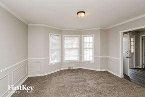 Memphis house for rent - a large empty room with three windows and a carpet