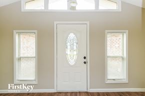 Euless house for rent - an empty room with a white door and two windows with blinds