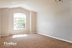 Kissimmee house for rent - an empty living room with a large window