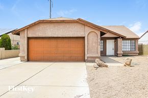 Phoenix house for rent - A house with a brown garage door is for sale.