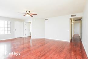 Phoenix house for rent - A room with a wooden floor and a ceiling fan.
