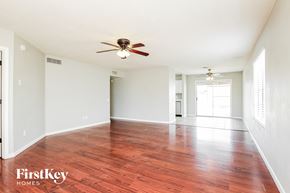 Phoenix house for rent - A room with a ceiling fan and wooden flooring.