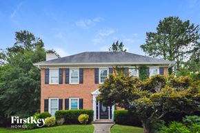Conyers house for rent - a brick house with a gray roof and a black door