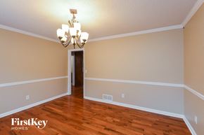 Conyers house for rent - a living room with a hard wood floor and a chandelier