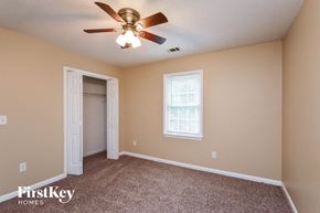Conyers house for rent - a bedroom with a ceiling fan and a closet