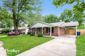 Florissant house for rent - A house with a red car parked in front of it.