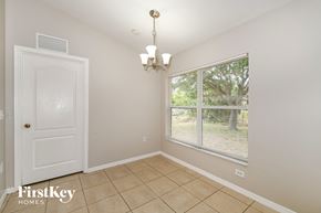 Cape Coral house for rent - a dining room with a large window and a tiled floor