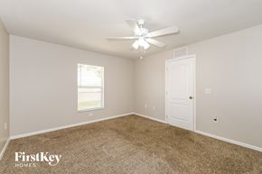 Cape Coral house for rent - a bedroom with carpet and a ceiling fan