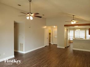 Katy house for rent - an empty living room with a ceiling fan