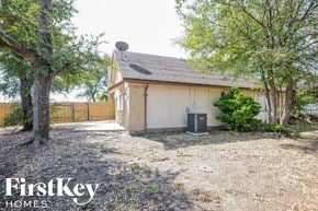 Carrollton house for rent - a small brick house with a yard and trees