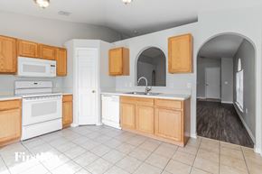 Winter Haven house for rent - a kitchen with white appliances and wooden cabinets