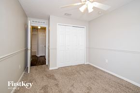 Winter Haven house for rent - a bedroom with a white door and a ceiling fan