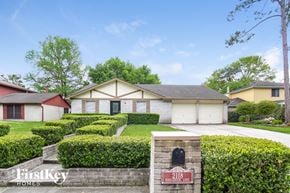 Spring house for rent - a home with manicured hedges in front of a driveway