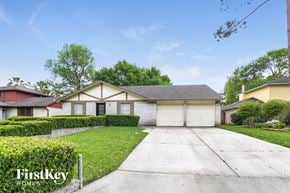 Spring house for rent - a home with white garage doors and a driveway