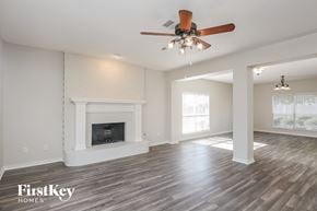 Rockwall house for rent - the living room with fireplace and ceiling fan