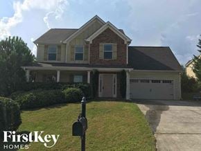 Dacula house for rent - a house with a driveway and a mailbox in front of it