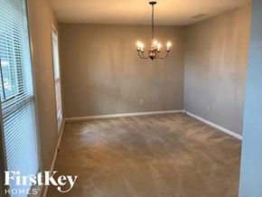 Dacula house for rent - a empty dining room with a chandelier and a window