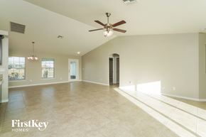 Cape Coral house for rent - a large empty living room with a ceiling fan