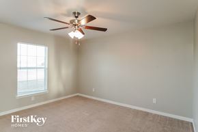 Cape Coral house for rent - a bedroom with a ceiling fan and a window