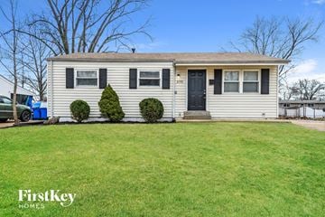 Florissant house for rent - a white house with black shutters and a lawn