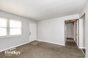 Florissant house for rent - a bedroom with white walls and carpet and a door to a hallway