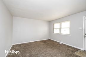 Florissant house for rent - a bedroom with white walls and carpet and a window