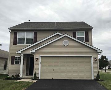 Grove City house for rent - the front of a house with a garage door