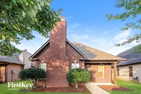 Moody house for rent - A brick house with a chimney and a sign that says "FirstKey Homes".