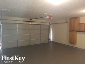 Mcdonough house for rent - A spacious garage with a FirstKey Homes logo on the wall.