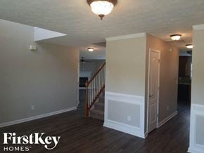 Mcdonough house for rent - A room with wooden floors and a staircase in the background.
