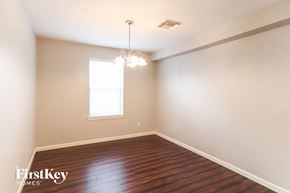 Katy house for rent - a empty dining room with wood floors and a window