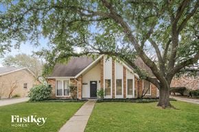 Katy house for rent - A brick house with a tree in front of it.