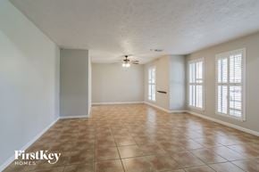 Katy house for rent - A room with a tile floor and a ceiling fan.
