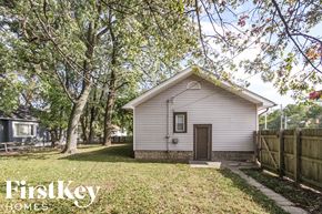 Indianapolis house for rent - a small white house with a yard and trees