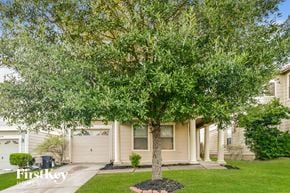 Humble house for rent - a tree in a yard in front of a house