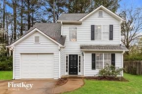 Marietta house for rent - A house with a garage and a black door.