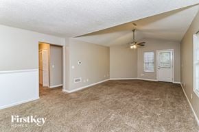 Marietta house for rent - A spacious room with a carpeted floor and a ceiling fan.