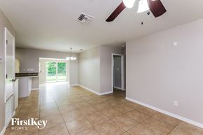 Margate house for rent - A spacious room with a ceiling fan and a door leading to a balcony.