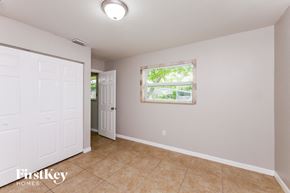 Margate house for rent - A room with a white door and a window with a view of trees.