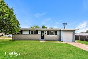 Florissant house for rent - a white house with a lawn and a blue sky