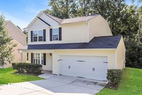 Greensboro house for rent - A two-story house with a white garage door.