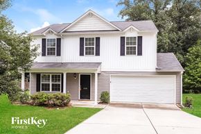 Greensboro house for rent - A white house with a black door and a garage door.