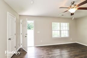 Greensboro house for rent - A room with a ceiling fan and a window.