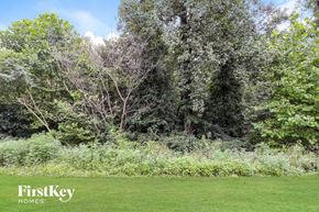 Greensboro house for rent - A lush green field with trees in the background.
