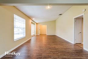 Orlando house for rent - an empty living room with wood flooring and a large window
