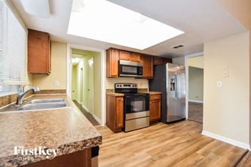 Orlando house for rent - a kitchen with wood flooring and stainless steel appliances