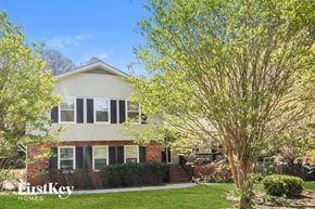Lawrenceville house for rent - a house with a lawn and trees in front of it